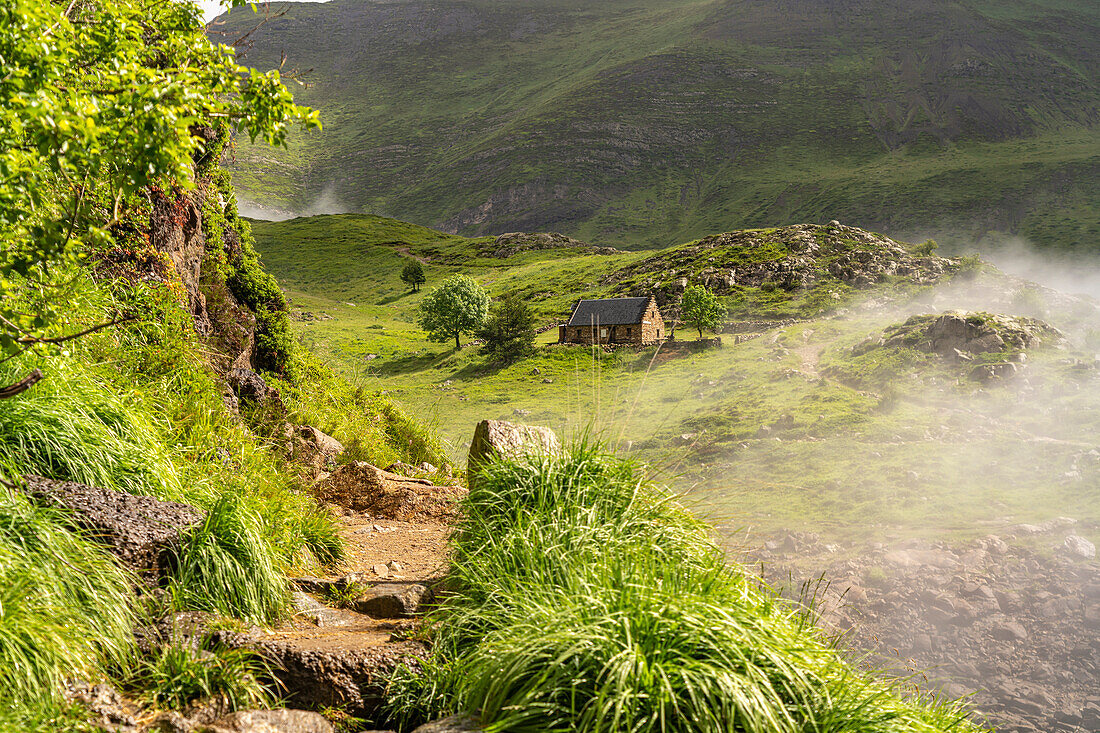  Hiking trail and mountain hut at the Lac des Gloriettes reservoir in the Pyrenees near Gavarnie-Gèdre, France, Europe 