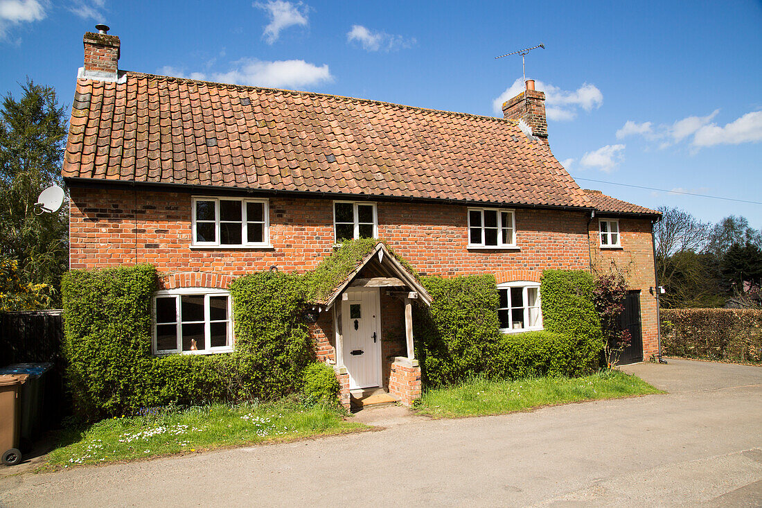 Red brick detached cottage in Shottisham, Suffolk, England, UK