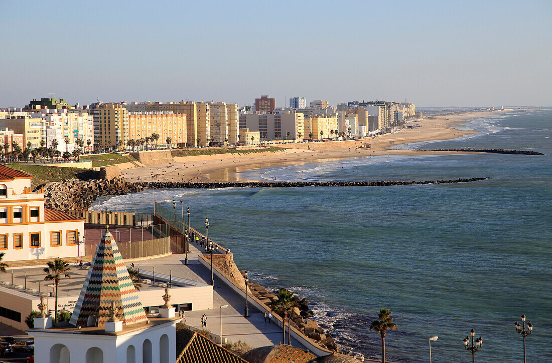 Coastal view east of sandy beaches and apartment housing, Cadiz, Spain