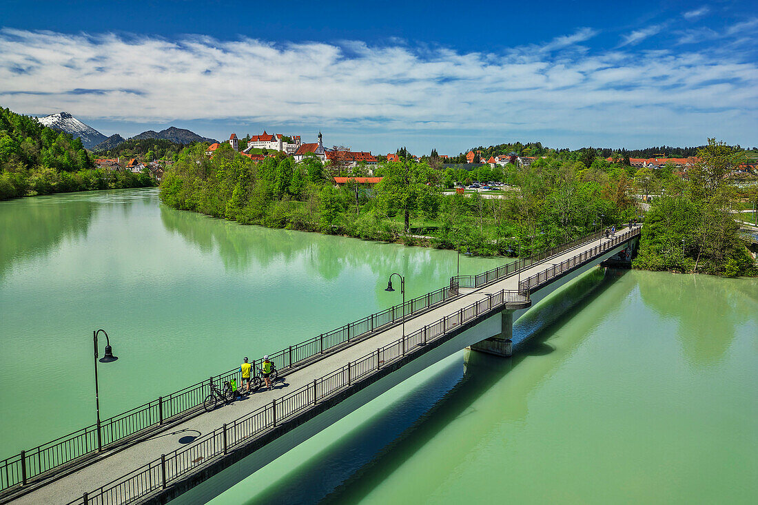  Man and woman cycling on the Lake Constance-Königssee cycle path over the Lech bridge to Füssen, Füssen, Allgäu, Swabia, Bavaria, Germany 