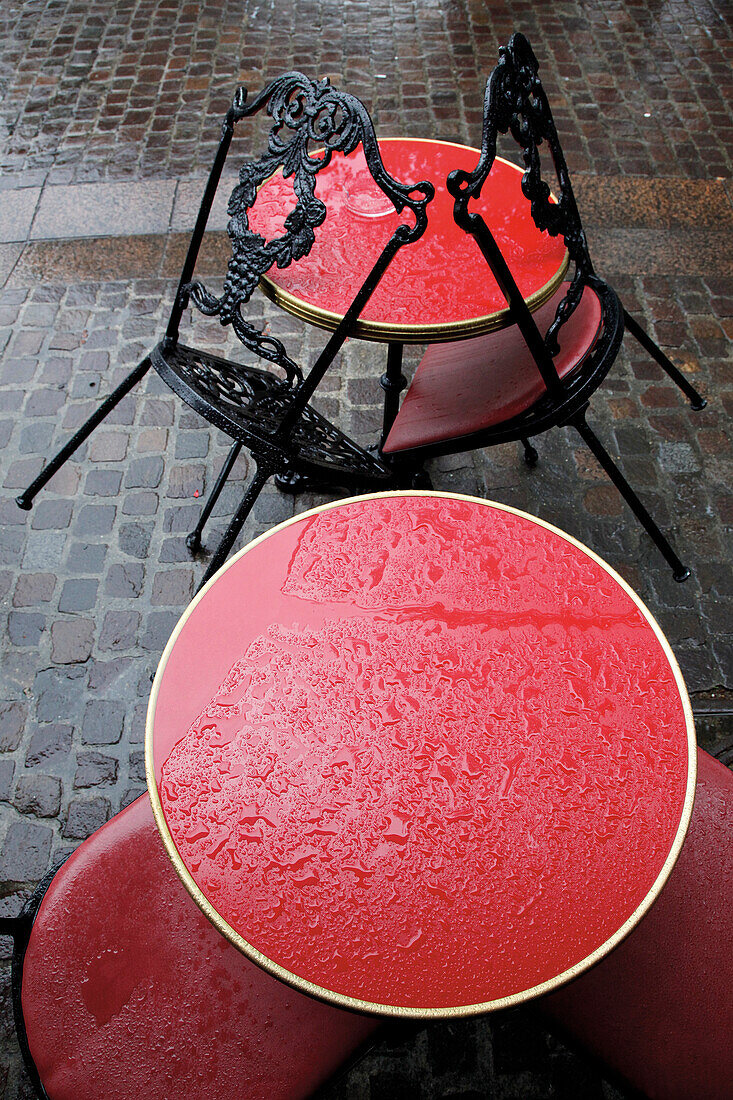   Bistrot tables red in the rain, Paris 