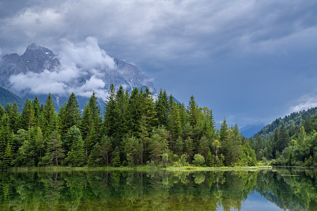  Thunderstorm atmosphere in the Karwendel at the Isar reservoir near Krün, Bavaria, Germany 