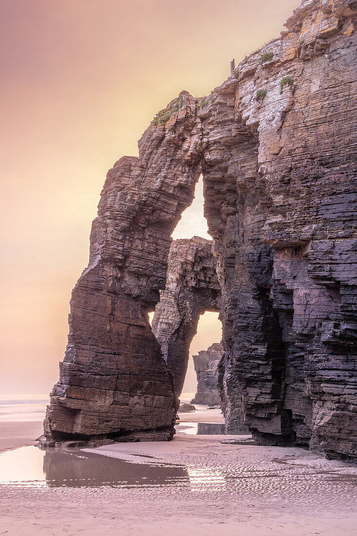  Several rock arches on the beach at Playa de las Catedralas in the golden morning light. 