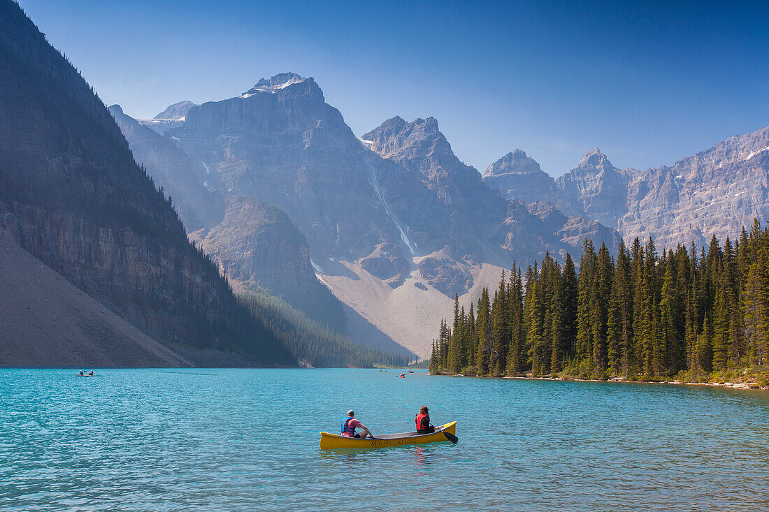  Canoeists in Moraine Lake in the Valley of the 10 Peaks, Banff National Park, Alberta, Canada 