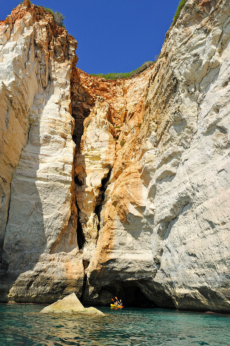 kayak at the entrance of a cave inside the cliff near Cala Galdana, South Coast of Cala Galdana, Menorca, Balearic Islands, Spain, Europe