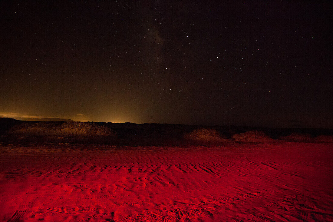 Epic view of a night sky filled with golden and red starlight.