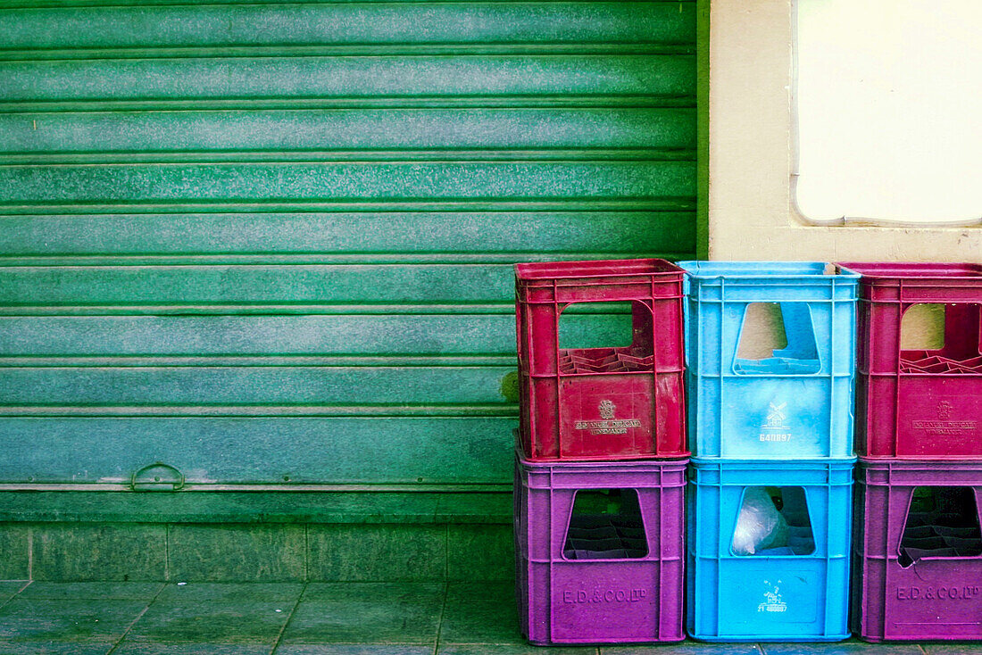 Bunte Bierkisten vor Rolltor, farbverfremdet auf der Insel Gomera, Kanarische Inseln, Spanien