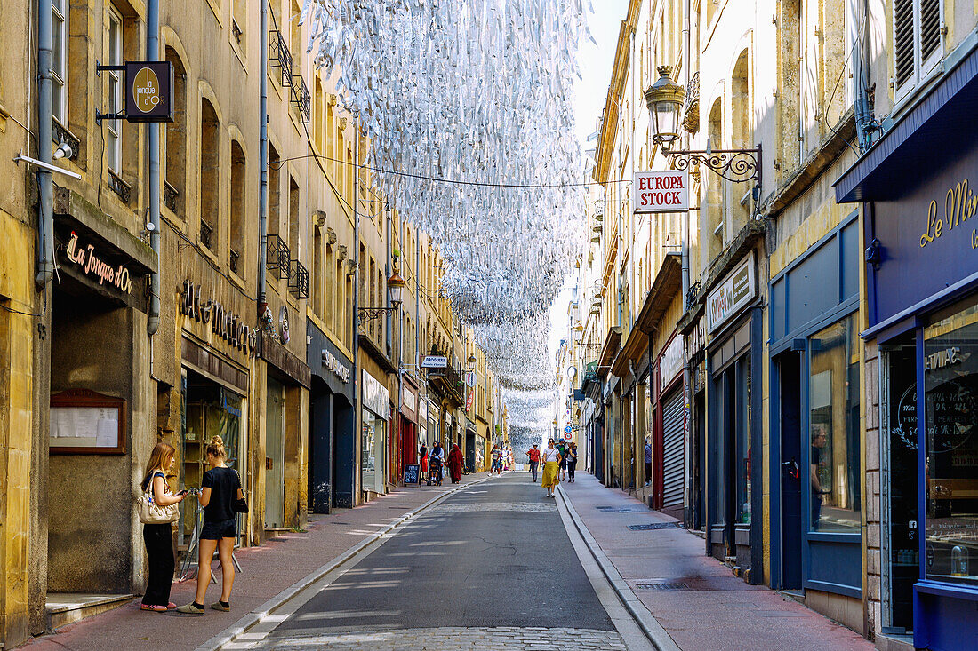  The old town street En Fournirue decorated with glittering silver stripes leading to Place Saint-Jacques in Metz in the Moselle department in the Grand Est region of France 