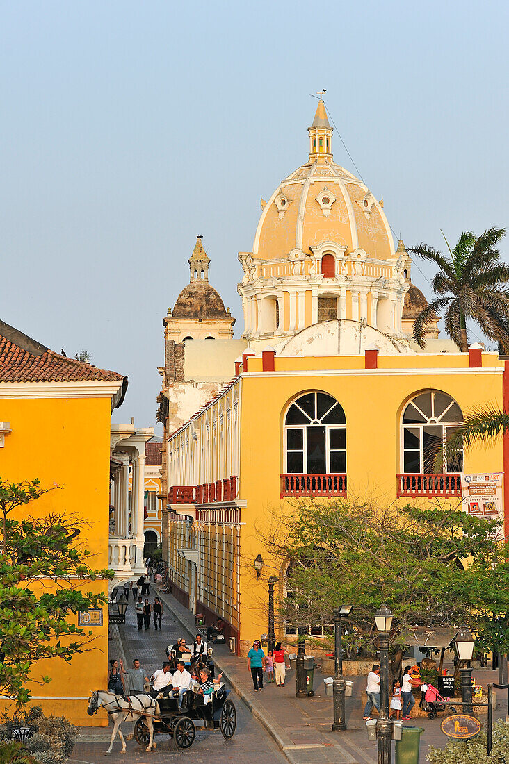 San Juan de Dios street with the dome of San Pedro Claver church in the background, downtown colonial walled city, Cartagena, Colombia, South America