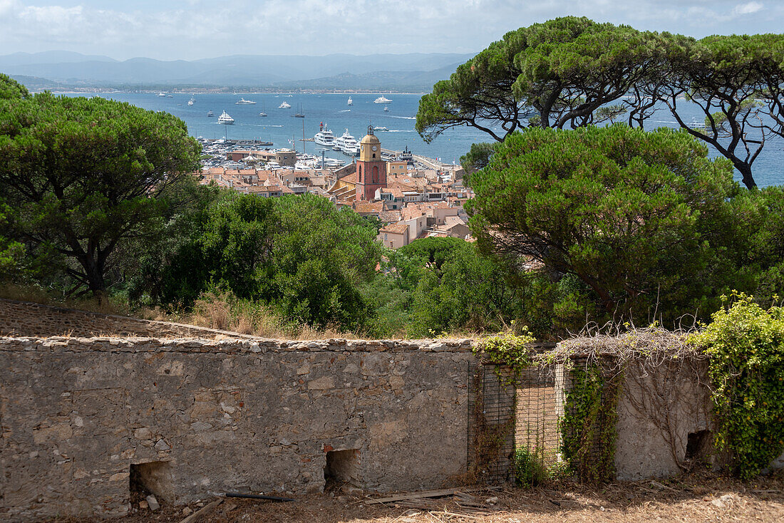 Blick über die Dächer von Saint Tropez mit der Kirche Notre-Dame de l'Assomption, dahinter die Bucht von Saint Tropez, Provence-Alpes-Côte d’Azur, Frankreich