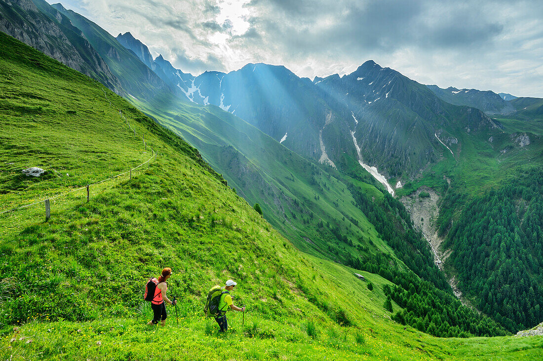  Man and woman hiking on the Pfunderer Höhenweg with Dengelstein in the background, Pfunderer Höhenweg, Zillertal Alps, South Tyrol, Italy 