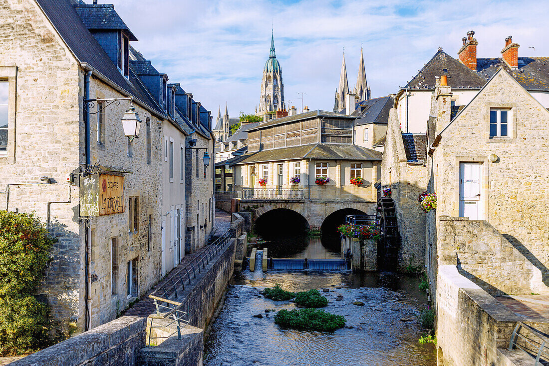  Old town of Bayeux with mill and stone bridge on the river l&#39;Aure and view of the Cathédrale Notre-Dame in Bayeux in the Bessin countryside in the Calvados department in the Normandy region of France 