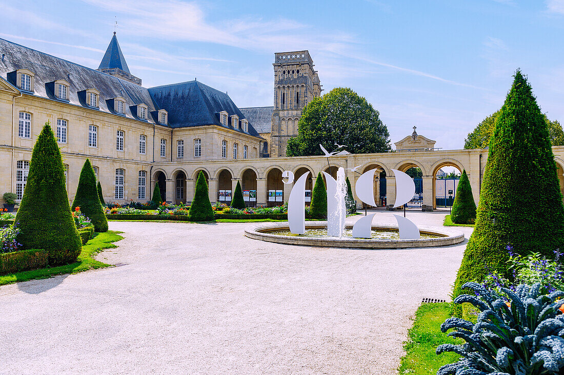  Monastery garden with arcade and view of the monastery buildings of the Abbaye aux Dames and the church Église Sainte-Trinité (Sainte-Trinite, Abbatiale de la Trinité) in Caen in the Calvados department in the Normandy region of France 