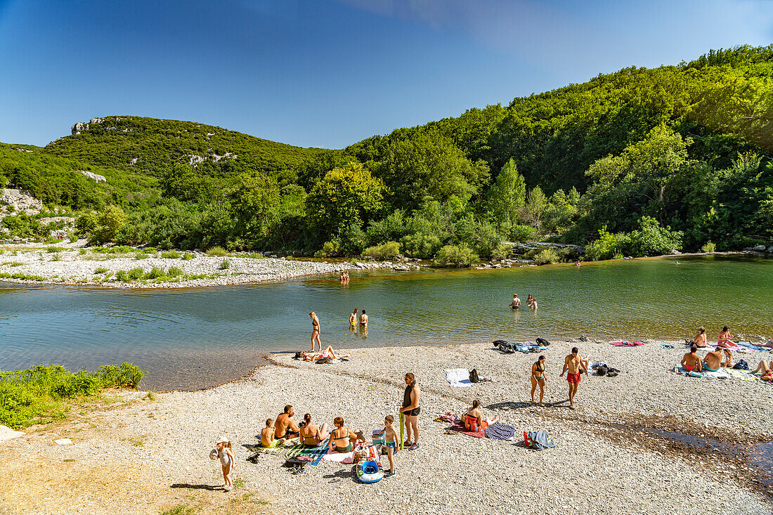  People bathing on the beach of the Hérault river near Laroque, France, Europe 