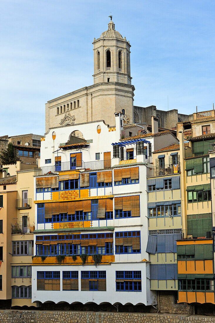 front of the houses, among which the white Casa Maso, birthplace of the Catalan architect Rafael Masó (1880-1935), by the Onyar River,  with the tower bell of the Cathedral in the background, Girona, Catalonia, Spain,Europe