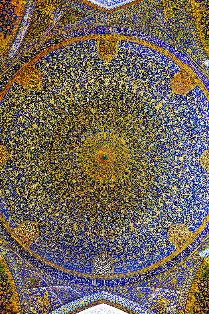 View from below of domed ceiling of the main prayer hall in the Shah Mosque (Masjed-e Shah) with its elaborate tiling. Isfahan, Iran.