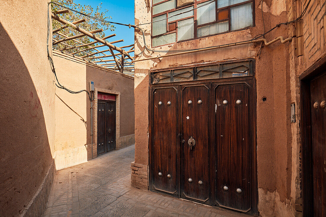 Front door of a traditional Iranian house on a narrow street in the old town of Yazd, Iran.