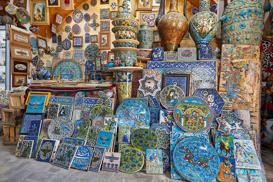 A selection of traditional handmade pottery and ceramics displayed in a gift shop in the historical Fahadan Neighborhood of Yazd, Iran.