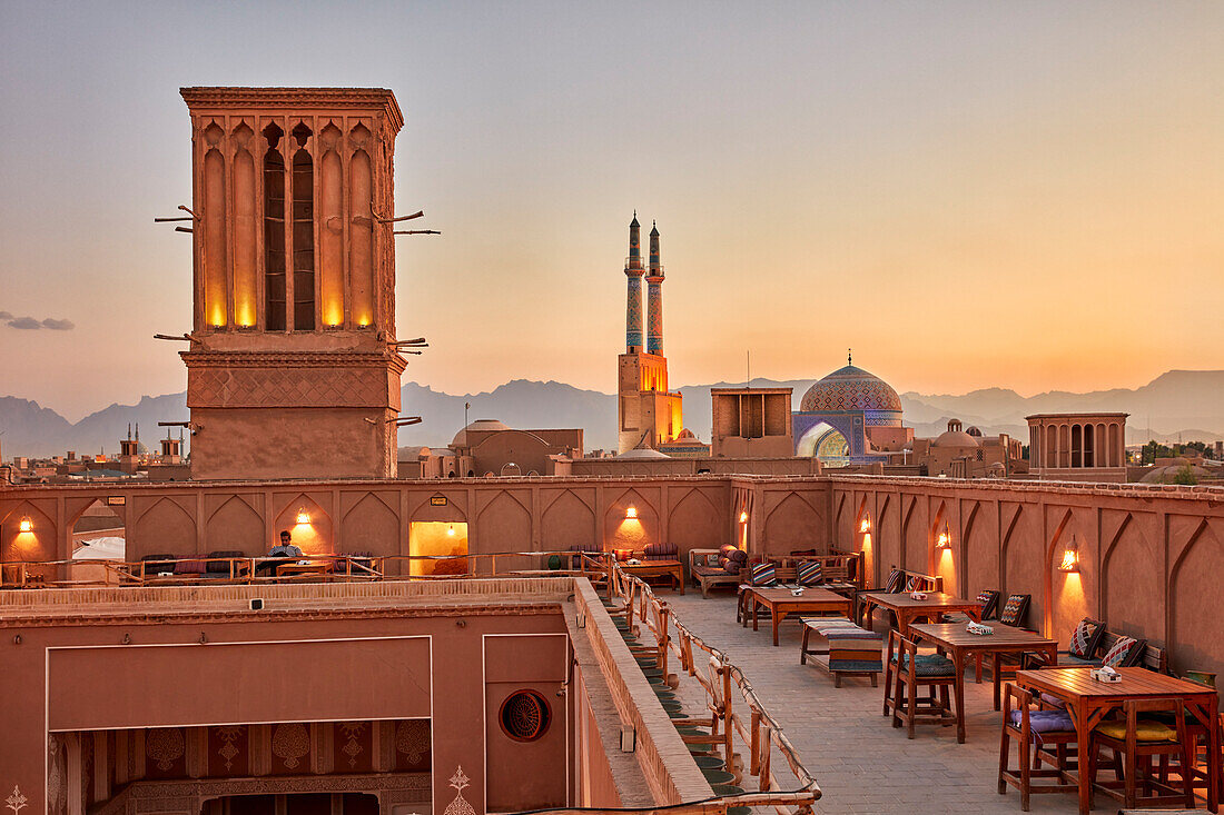 Rooftop terrace of the Cafe Nardoon in the historical Fahadan Neighborhood at sunset. Yazd, Iran.