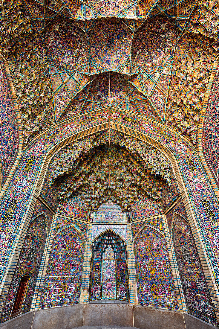 Elaborate multi-colored tilework on an iwan’s walls and ceiling of the 19th century Nasir al-Mulk Mosque, aka the Pink Mosque. Shiraz, Iran.