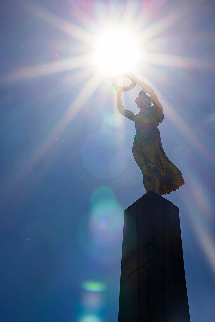  Silhouette of the “Gëlle Fra” monument (Monument of Remembrance) against sun, Luxembourg, Luxembourg, Europe 