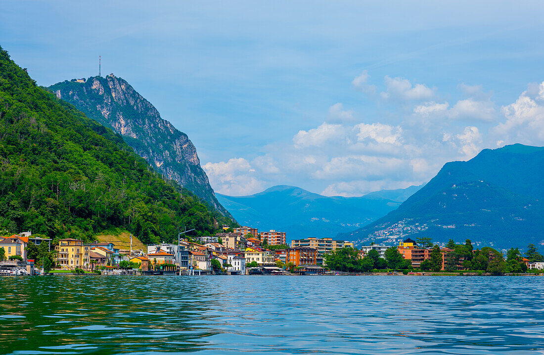 Elegant House on the Mountain Side in a Sunny Summer Day on the Waterfront to Lake Lugano in Melide, Lugano, Ticino, Switzerland.