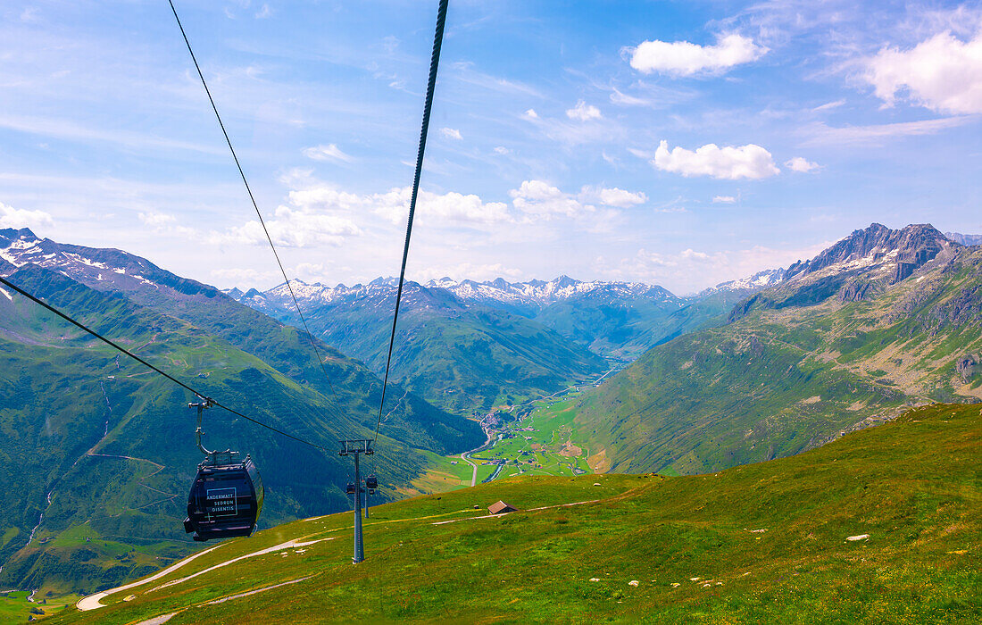 Beautiful Panoramic View From Overhead Cable Car over the Golf Course with Mountainscape and Mountain Valley in a Sunny Summer Day in Andermatt, Uri, Switzerland.