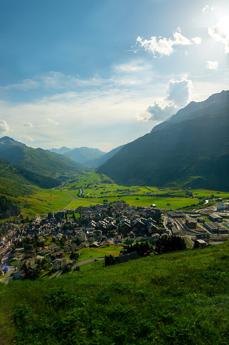 Beautiful Panoramic View over Old Cityscape and Golf Course with Mountainscape and Mountain Valley in a Sunny Summer Day in Andermatt, Uri, Switzerland.