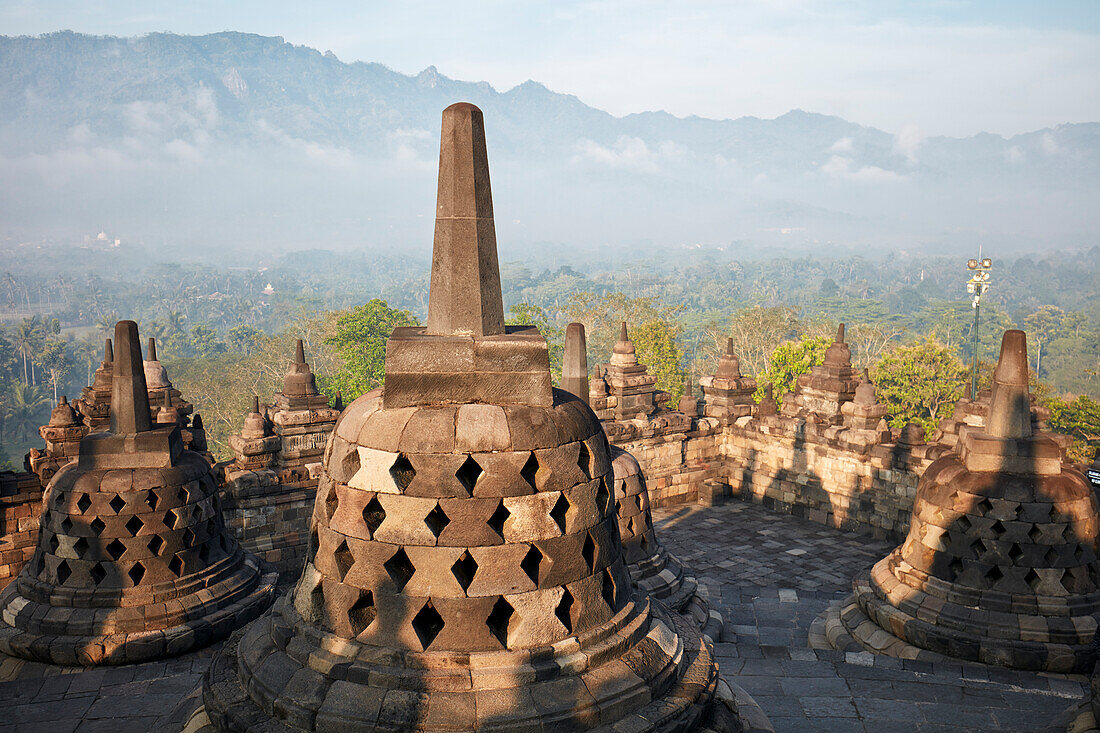 Rhombus holed stupas in the Borobudur, 9th-century Mahayana Buddhist temple. Magelang Regency, Java, Indonesia.