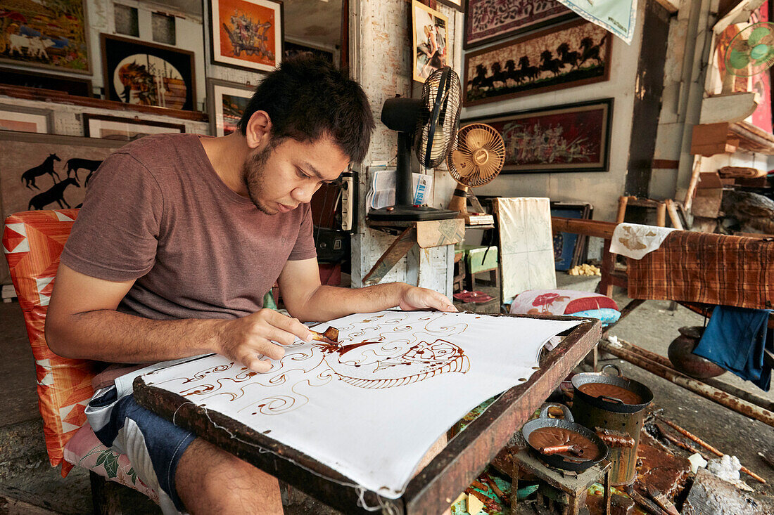  Ein Batikmacher arbeitet in seiner Werkstatt bei Batik Seno, einer Galerie in Yogyakarta, Java, Indonesien. 