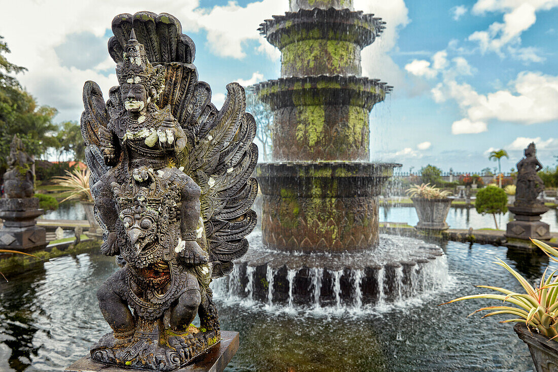 Carved stone statue in the Tirta Gangga water palace, a former royal palace. Karangasem regency, Bali, Indonesia.