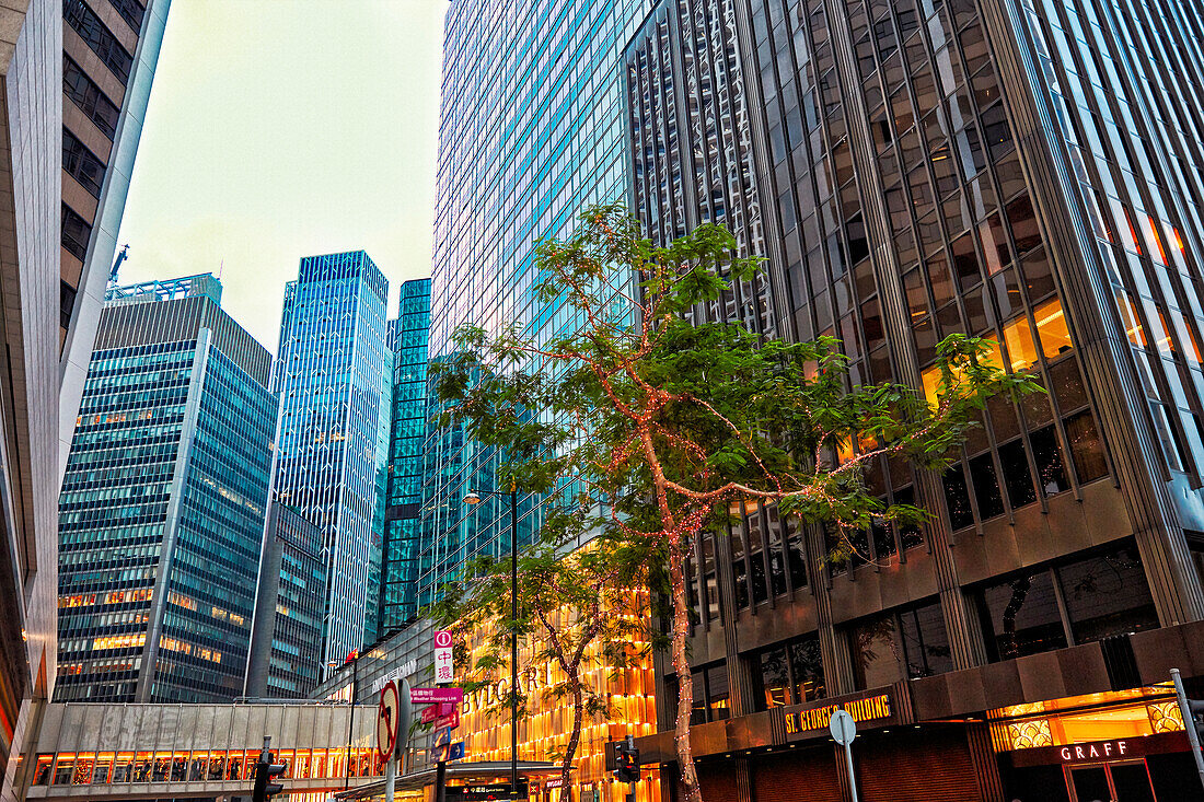 Modern high-rise buildings on the Chater Road illuminated at dusk. Central, Hong Kong, China.