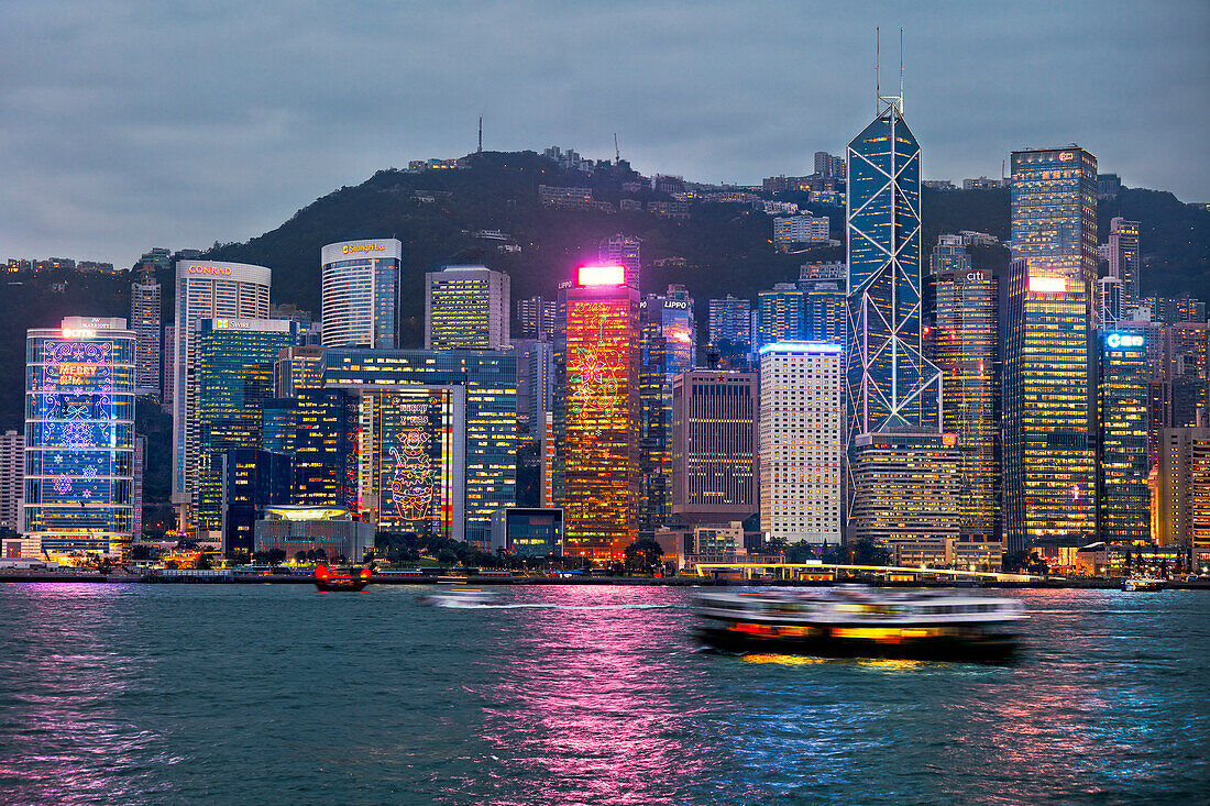 Iconic view of the Central Waterfront high-rise buildings illuminated at dusk. Hong Kong, China.