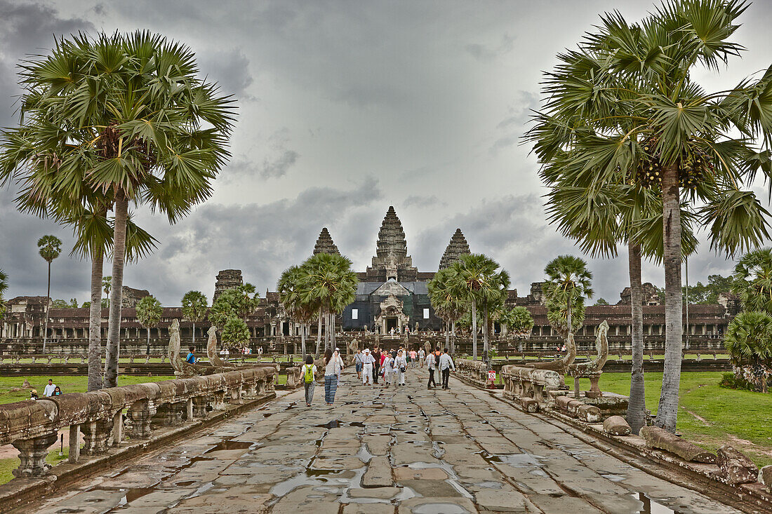 Tourists walk in the Angkor Wat temple. Angkor Archaeological Park, Siem Reap Province, Cambodia.