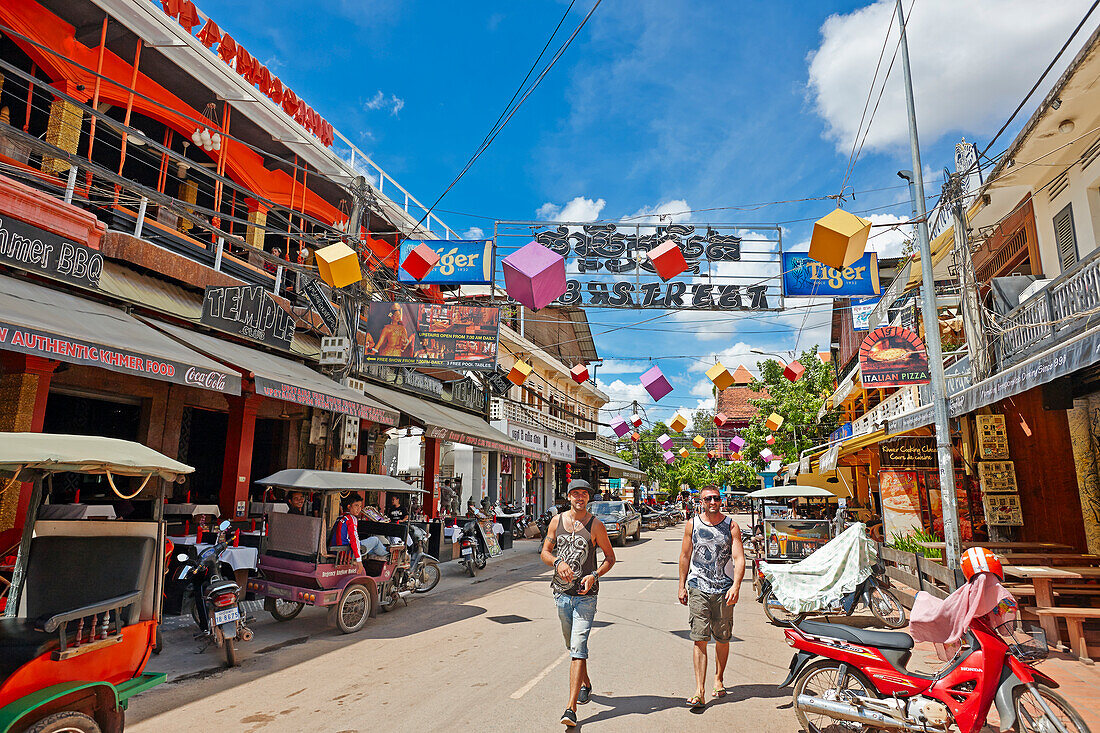 Tourists walk in a narrow street in the Old French Quarter of Siem Reap town, Cambodia.