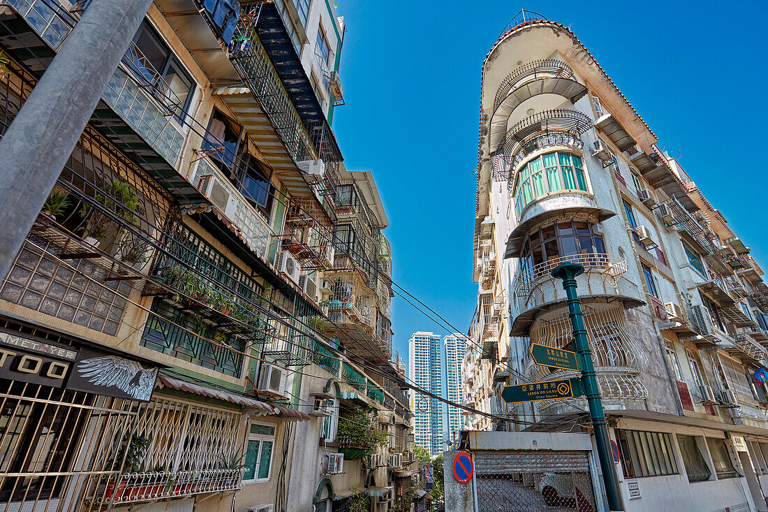 Residential buildings with fenced windows and balconies in the historic centre of Macau city, China.