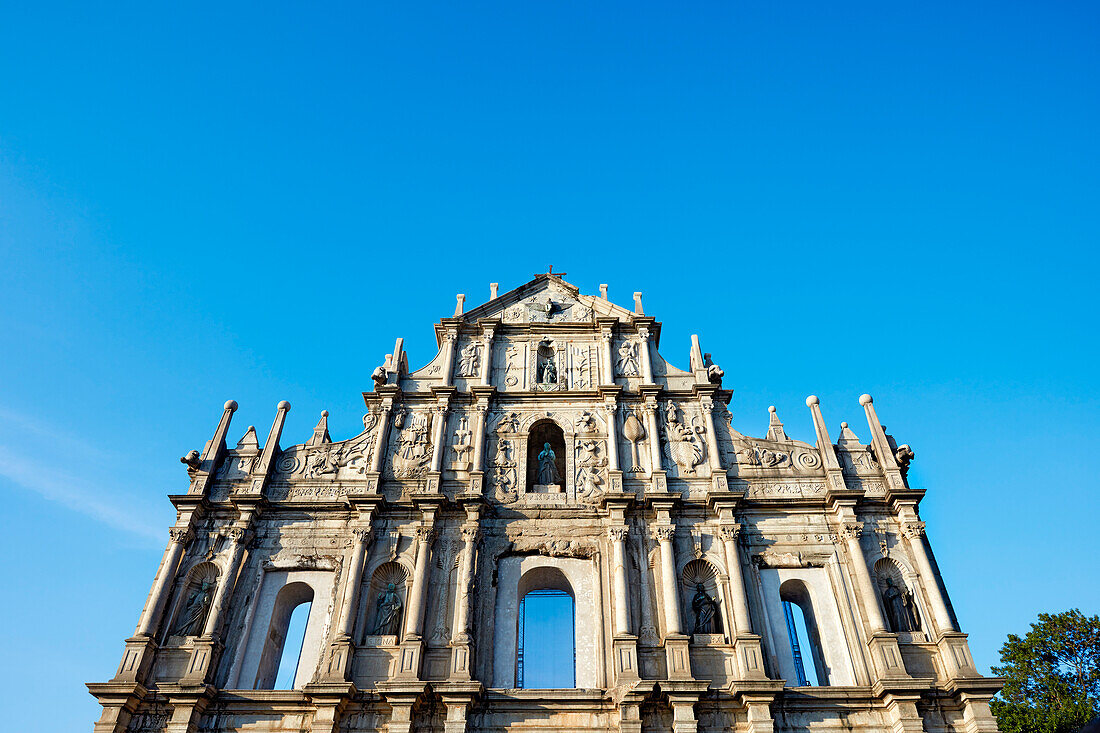 Intricately carved southern stone facade of the Ruins of Saint Paul's, now one of Macau's best known landmarks. Macau, China.