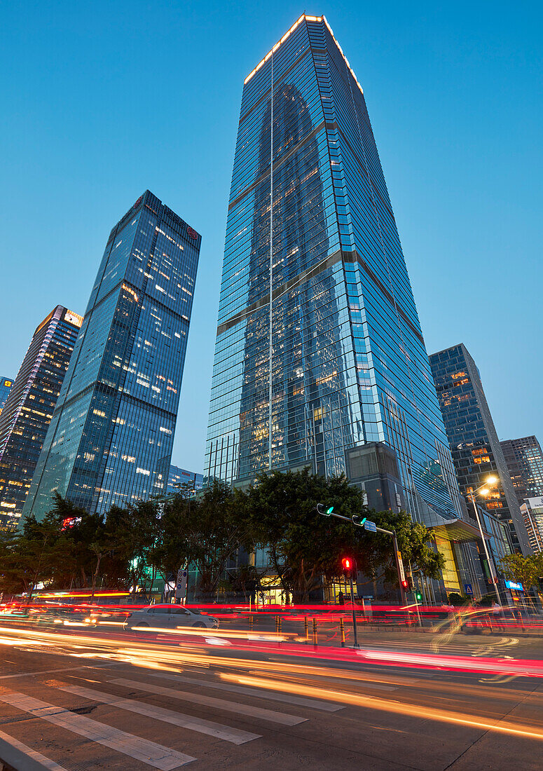 High-rise buildings in Futian Central Business District (CBD) illuminated at dusk. Shenzhen, Guangdong Province, China.