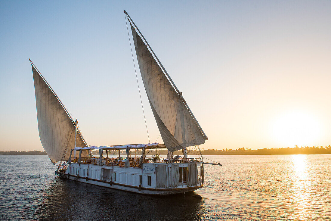 Dahabeah under sail, passenger river boat of the Lazuli fleet, sailing on the Nile river near Aswan, Egypt, northeast Africa