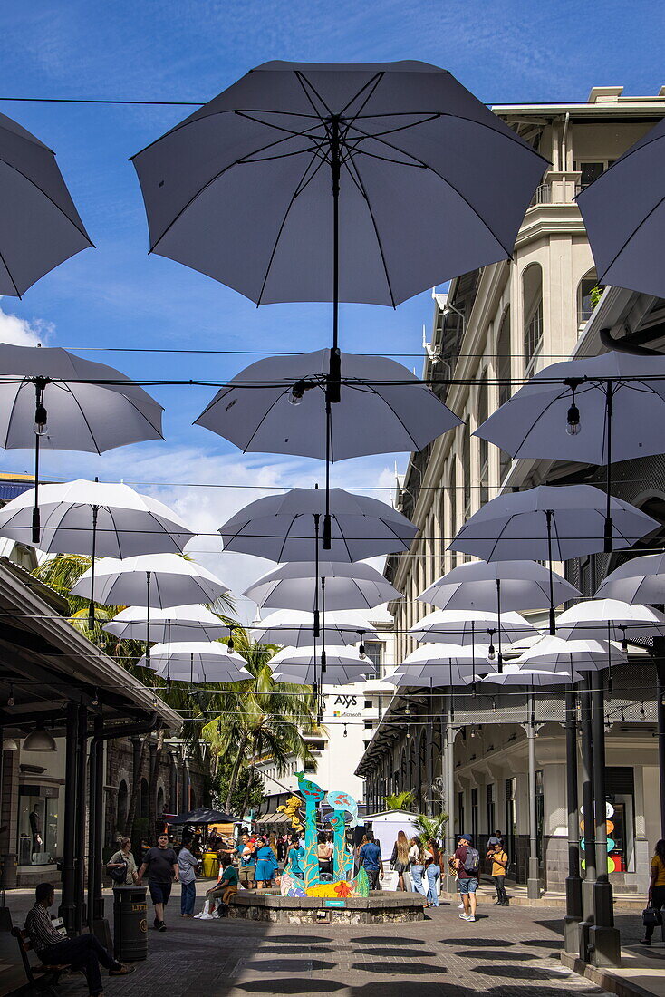  White umbrellas in the pedestrian zone at the Barkly Wharf harbor and shopping center, Port Louis, Port Louis, Mauritius, Indian Ocean 