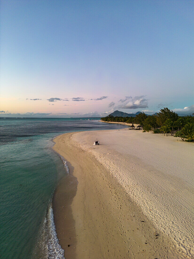  Aerial view of a wedding photo session on the beach at Paradis Beachcomber Golf Resort 