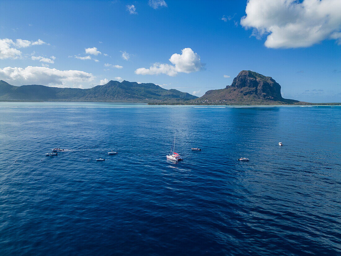  Aerial view of tour boats in the sea during a whale and dolphin watching tour with coastline and Le Morne mountain in the distance, Le Morne, Rivière Noire, Mauritius, Indian Ocean 