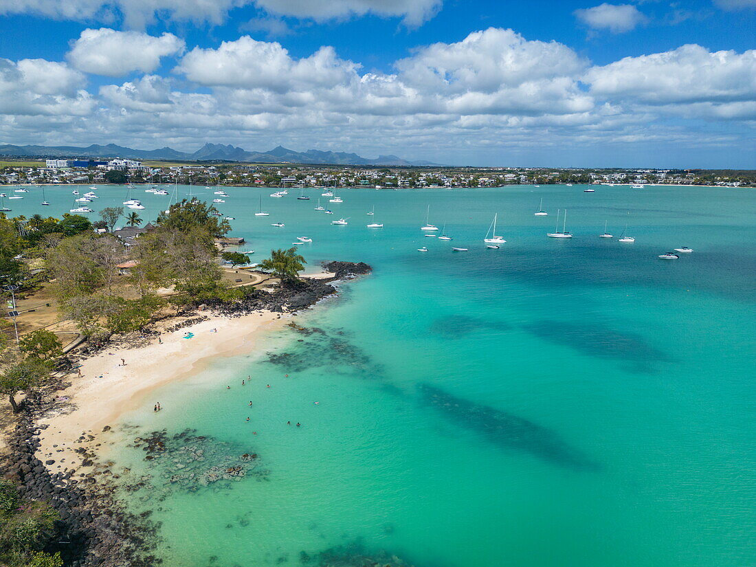  Aerial view of people on beach with sailboats in lagoon, Grand Baie, Rivière du Rempart, Mauritius, Indian Ocean 