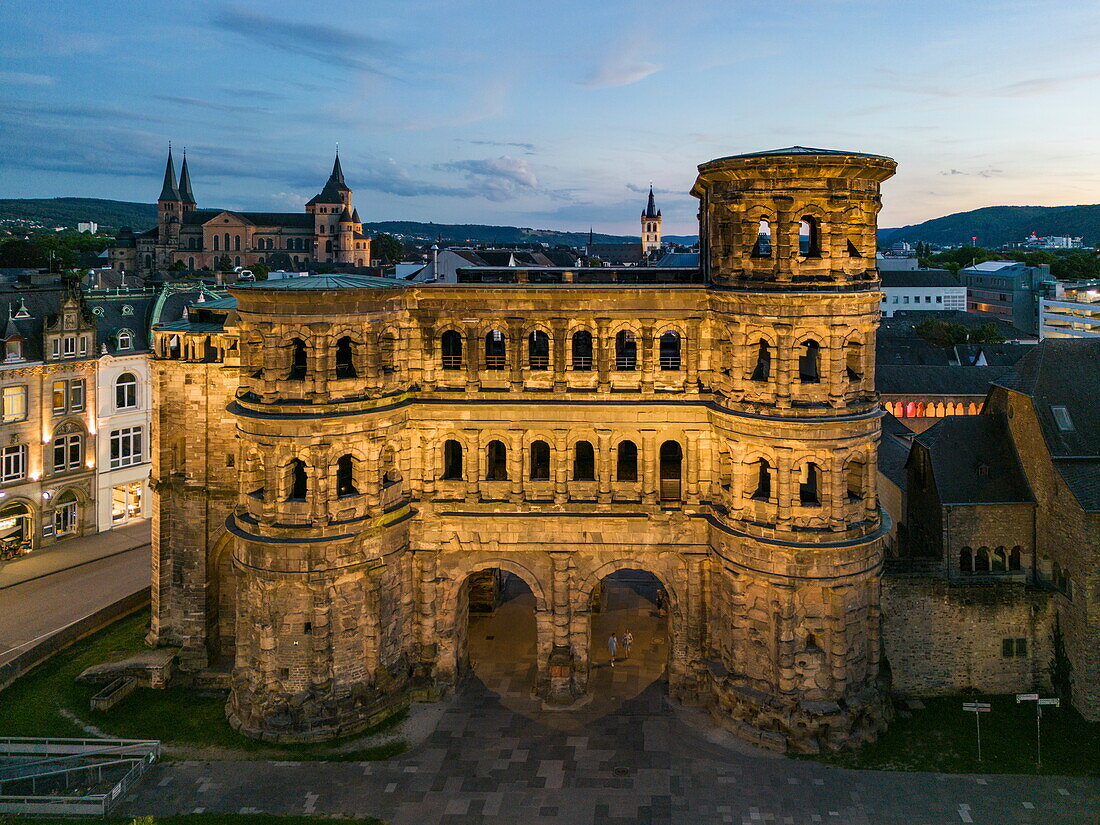  Aerial view of the ancient Roman city gate Porta Nigra and the city at dusk, Trier, Rhineland-Palatinate, Germany, Europe 