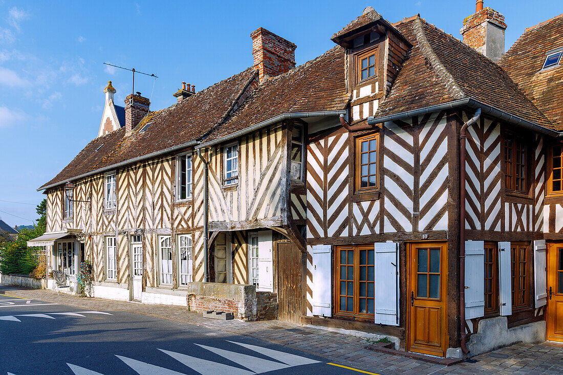  Main street with half-timbered houses in Beuvron-en-Auge in the Pays d&#39;Auge in the Calvados department in the Normandy region of France 