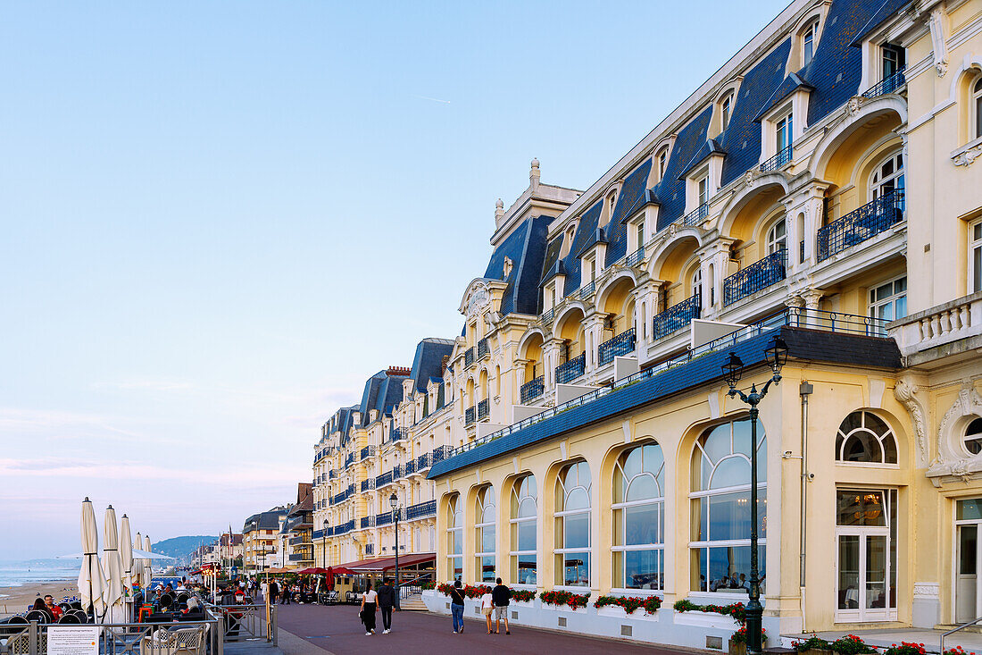  Beach promenade (Promenade Marcel Proust) with Grand Hotel (Le Grand Hôtel) and beach view at sunset in the evening light in Cabourg on the Flower Coast (Côte Fleurie, Cote Fleurie) in the Calvados department in the Normandy region of France 