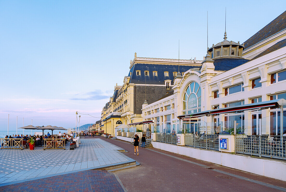 Beach promenade (Promenade Marcel Proust) with Casino de Cabourg and beach view at sunset in the evening light in Cabourg on the Flower Coast (Côte Fleurie, Cote Fleurie) in the Calvados department in the Normandy region of France