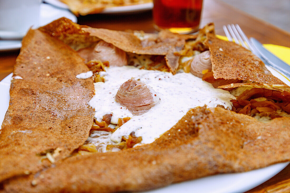  Galette with tripe sausage (Andouille sausage, Andouille de Guémené), onions, mustard, cheese and crème fraîche, served on the Flower Coast (Côte Fleurie, Cote Fleurie) in the Calvados department in the Normandy region of France 