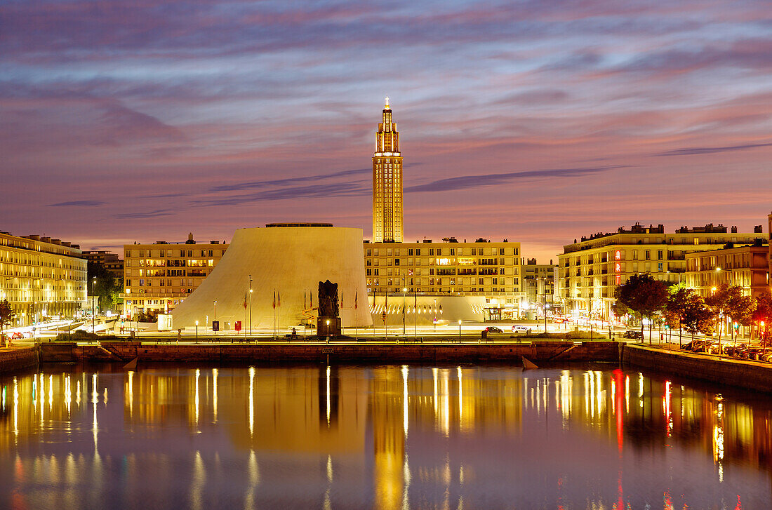  Bassin du Commerce with water reflection and view of the cultural center Espace Oscar Niemeyer with ›Grand Volcan‹ (Big Volcan) and ›Petit Volcan‹ (Small Volcano) and Saint-Joseph church at sunset in the evening light in Le Havre on the Alabaster Coast (Côte d&#39;Albatre, Cote d&#39;Albatre) in the Seine-Maritime department in the Normandy region of France 