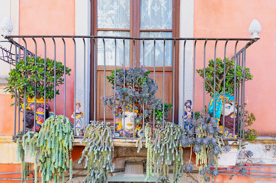 Balcony adorned with traditional ceramic pots, Taormina, Sicily, Italy